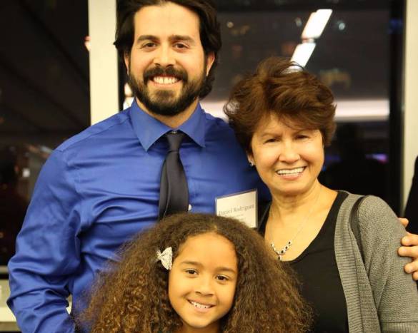 Daniel Rodriguez stands proudly with his family. 