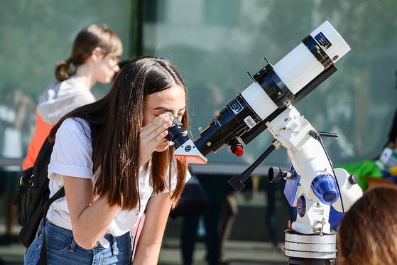 women using telescope