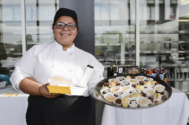 Student shows the food at taste of mesa event